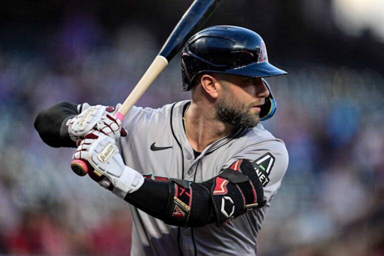 Christian Walker, Arizona Diamondbacks first baseman, stepping up to the plate during a game in April 2024, focusing intently on the pitcher as he prepares for his at-bat.